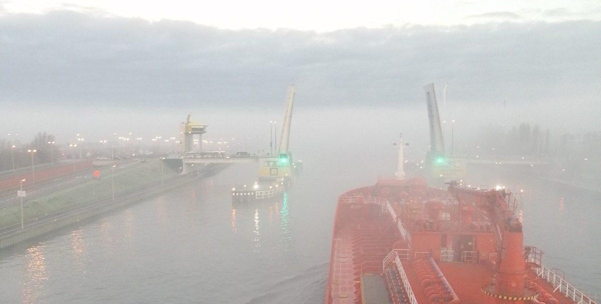 Tanker deck and cargo pipelines under overcast sky